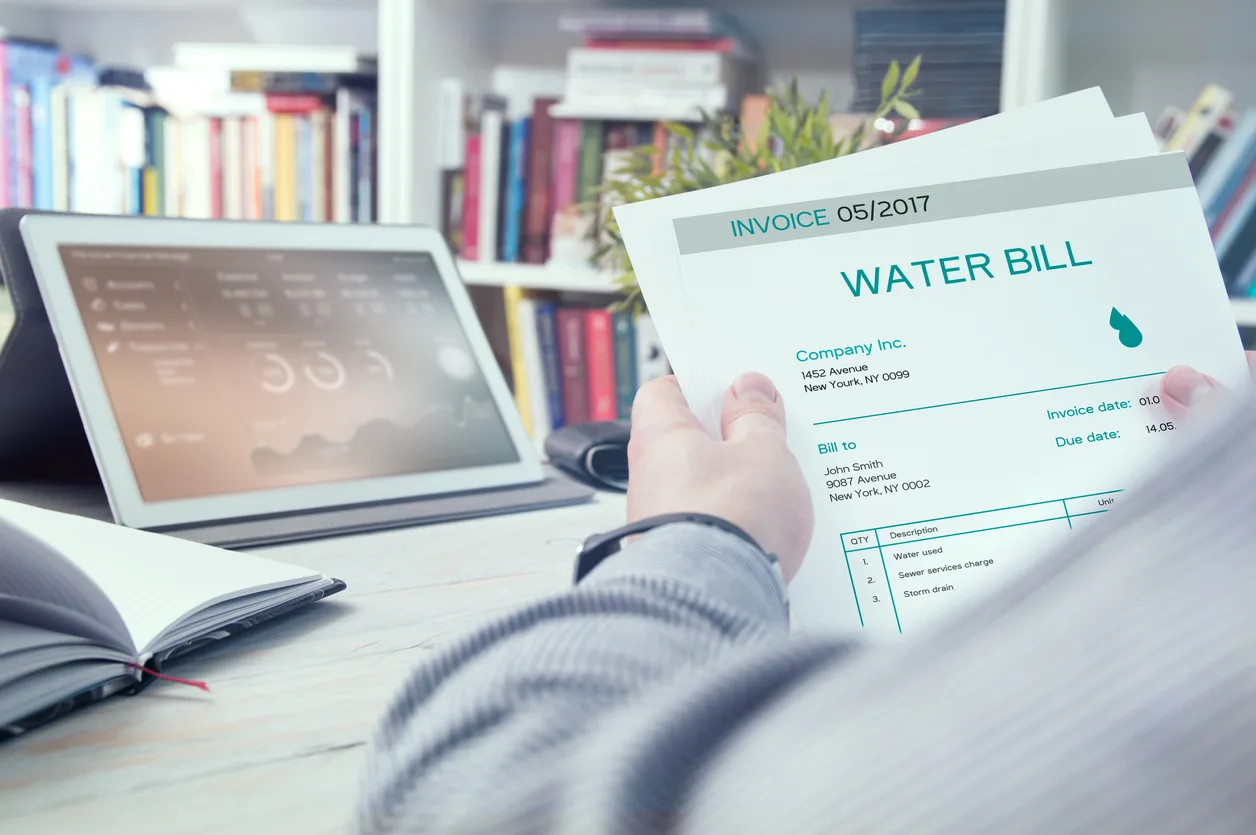 Mesa homeowner reviewing water bill during Arizona summer