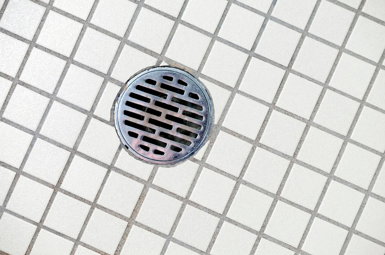 Phend Plumbing technician inspecting a drain line for odor causes in a Mesa home