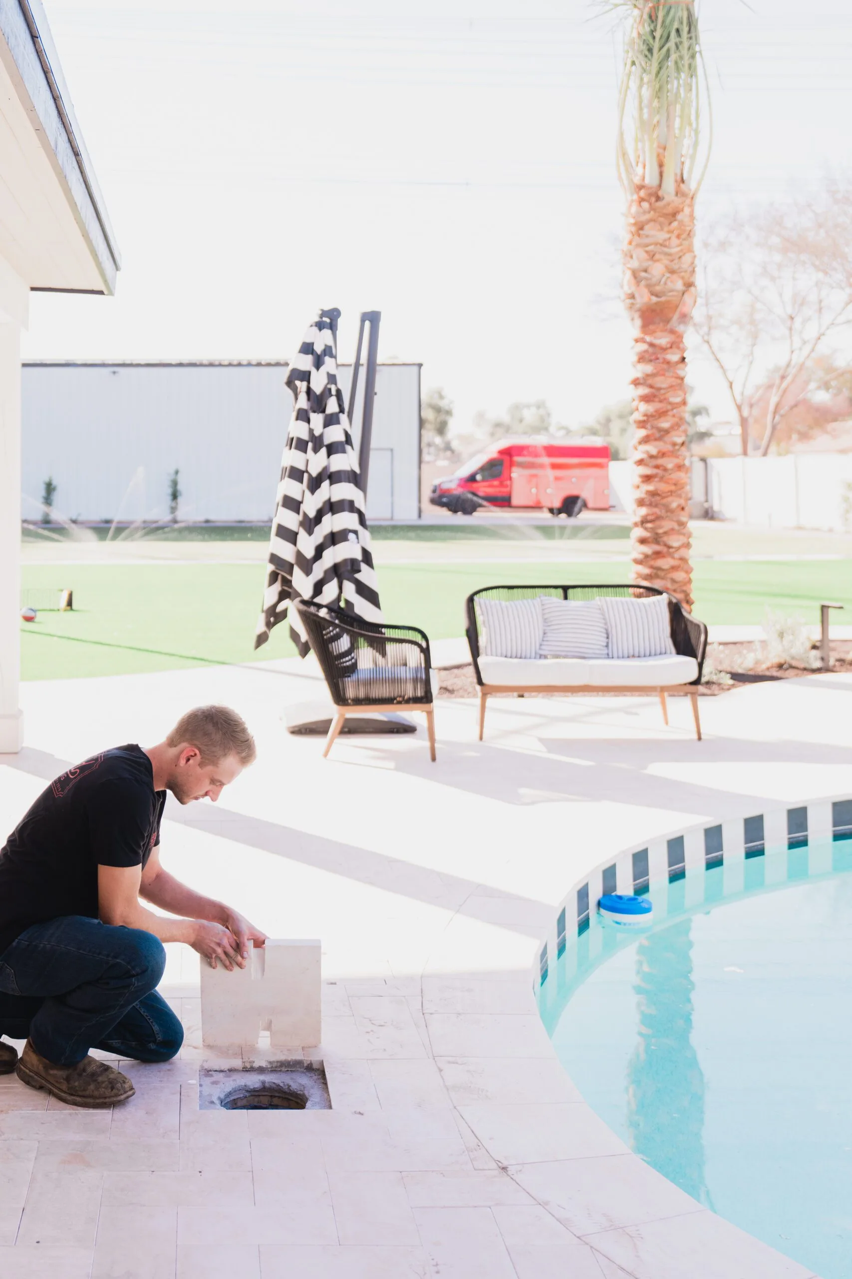 Phend Plumbing technician working on outdoor plumbing at a poolside East Valley home