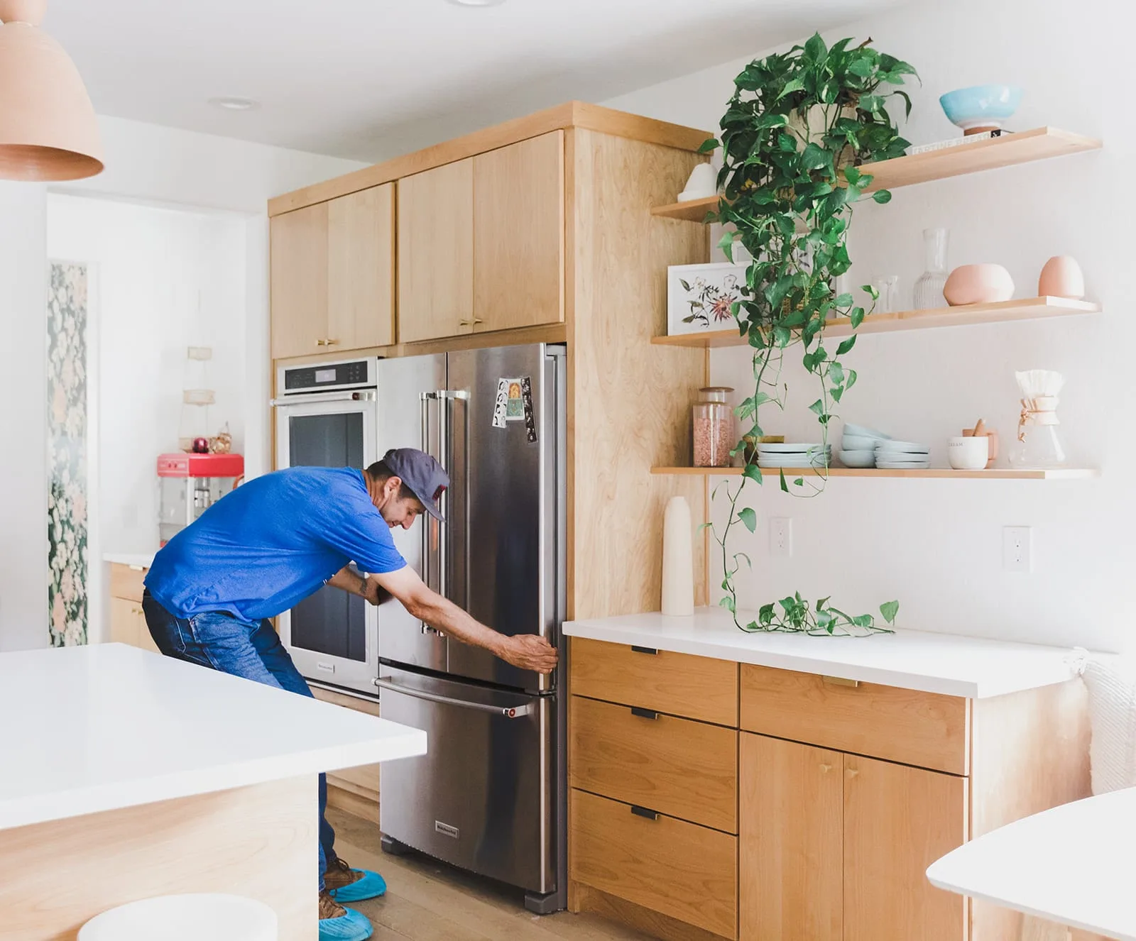 Phend Plumbing technician servicing kitchen appliances in an East Valley home