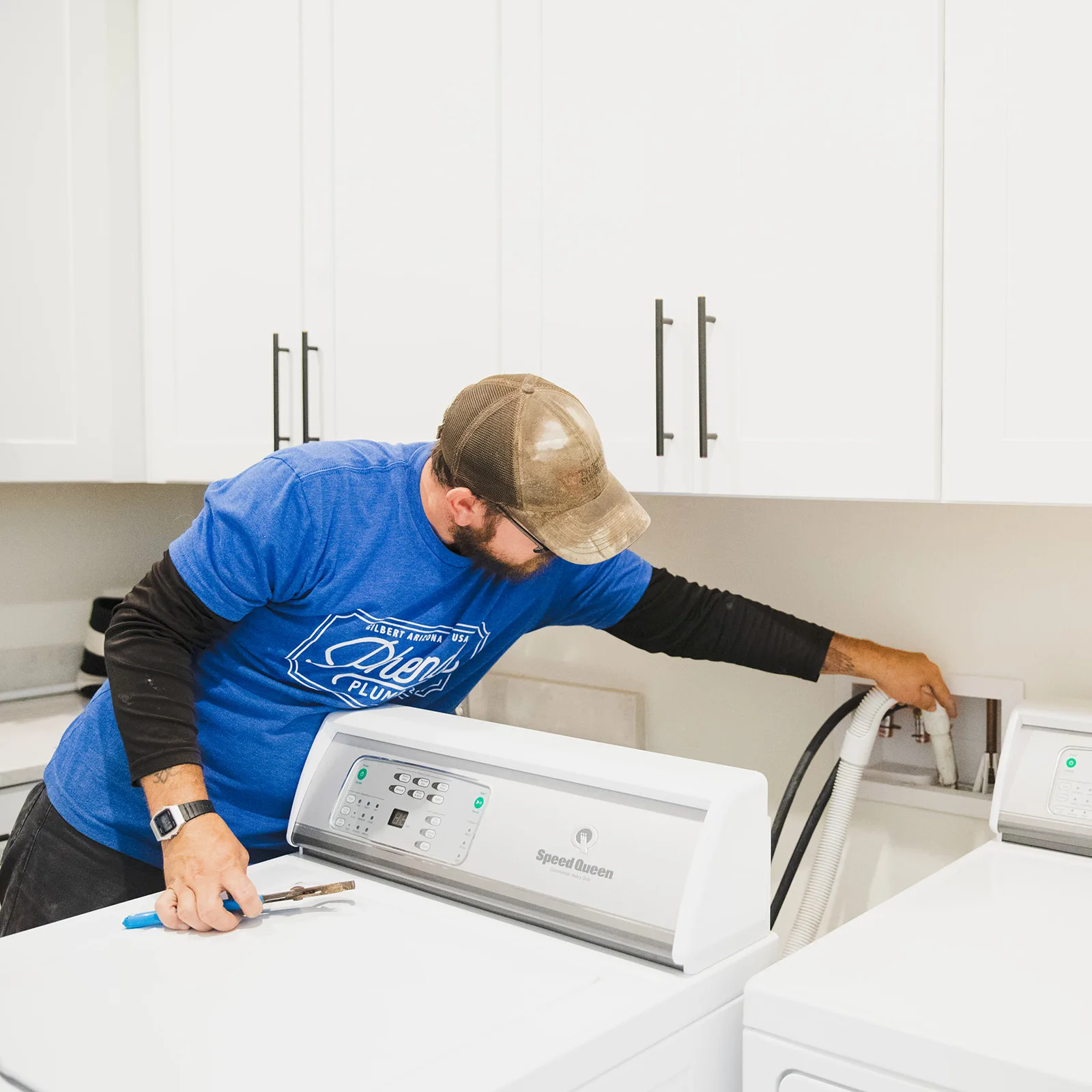 Phend Plumbing technician replacing shutoff valves at a washing machine supply box in an East Valley home